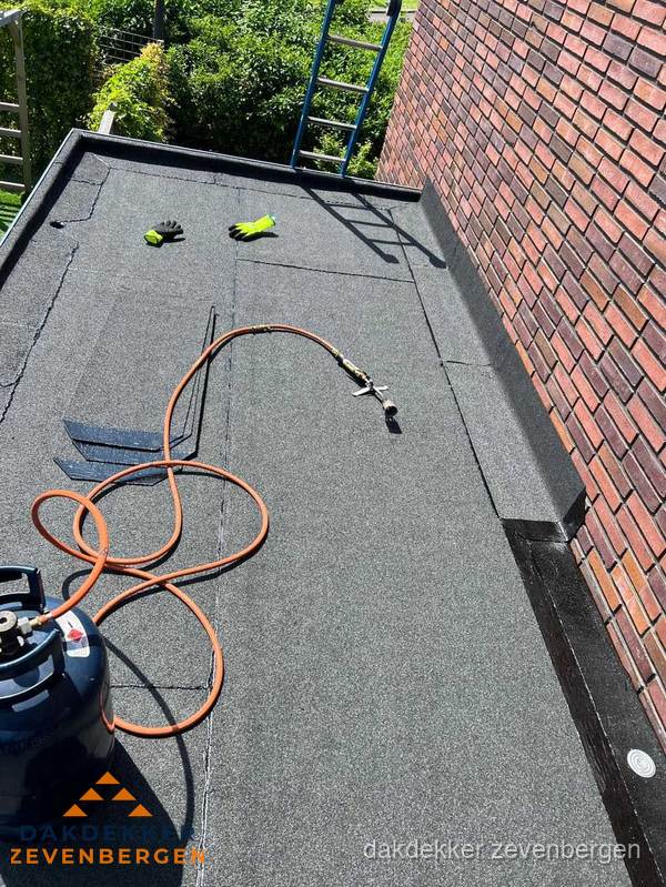 Plat dak met bitumen en brandgereedschap van dakdekkersbedrijf in Zevenbergen Plat dak met bitumen en brandgereedschap van dakdekkersbedrijf in Zevenbergen